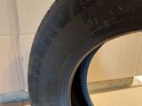 a close up of a tire on a wooden floor in a room