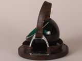 a black ball with a brown leather strap on it