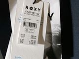 a tag that says roxy on it hanging from a hanger