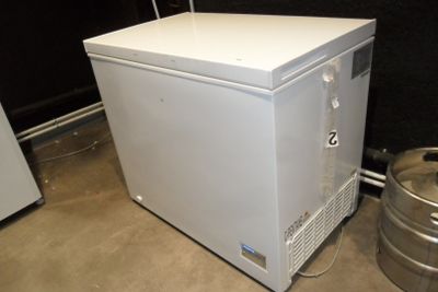 an image of a small white refrigerator in a room