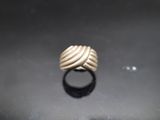 a close up of a gold ring on a black surface