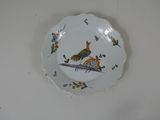 a plate with a bird on it sitting on a table