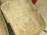 a wooden chair that has a fire extinguisor on it