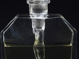 a clear glass bottle with a liquid inside of it