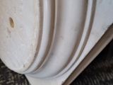 a close up of a white vase on a carpet