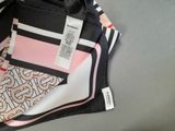 a black and white bag with a pink and black design on it