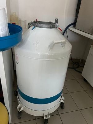 a large white tank sitting next to a blue bucket