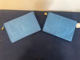 two pieces of blue fabric on top of a blue mat