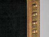a gold frame with a black background in the room