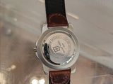 a close up of a watch on a glass table