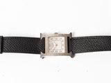 a close up of a watch on a black leather strap