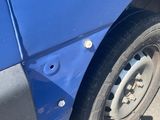 a blue car that has a flat tire on it