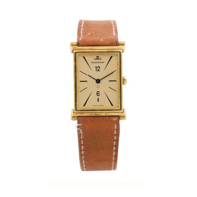 a close up of a watch on a white surface with a white background