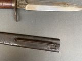 two knives that are laying next to each other on a table