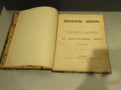 an open book sitting on top of a table next to a glass case