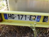 a yellow truck that has a license plate on it