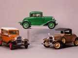 three toy cars that are sitting on top of each other