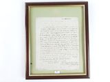 a framed picture of a letter on the wall