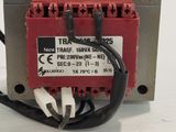 a red transformer with wires connected to it on a white surface