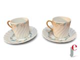 two cups and saucers sitting on top of each other