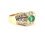 an image of a gold ring with a green emerald and white diamonds