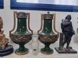 trois vases posés sur une étagère à côté d'une statue
