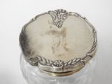 an antique silver plated jar with a lid on a white surface