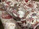 bedspread with a floral pattern and a glass bowl on top of it