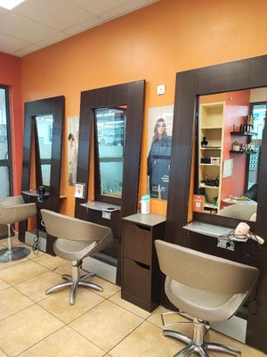 an image of a hair salon with chairs and mirrors