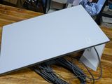 a laptop computer sitting on top of a wooden table