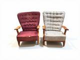 pair of mid - century danish lounge chairs with upholstered cushions