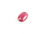 a close up of a pink stone on a white surface