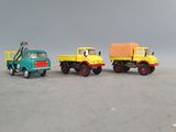 three toy trucks that are sitting next to each other