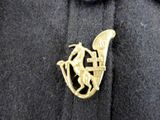 a gold brooch with a horse and a man riding a horse
