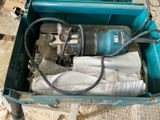 a blue box with a drill and a newspaper in it