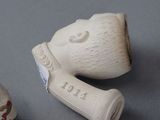 two small ceramic objects that are on a table