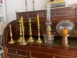 a lot of candles that are sitting on top of a dresser