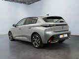 the rear end of a silver car in a white room
