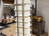 a large stack of buckets sitting on a cart in a kitchen