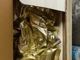 a cardboard box full of coffee bags and a cup