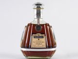 an image of a bottle of brandy sitting on top of a table