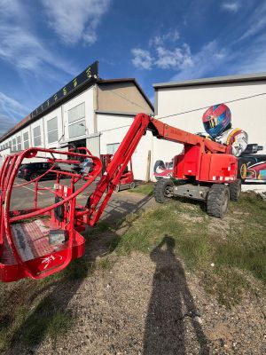 a red crane that is parked in front of a building