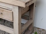 a small wooden table with two drawers on it