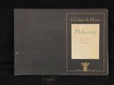 a black book with gold lettering on it sitting on a black surface