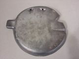 a small metal object on a table with a white background