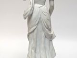 statue of a woman in a white dress with a shawl around her neck