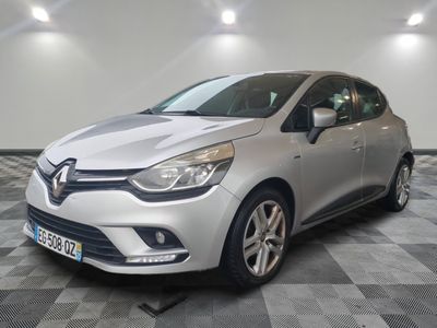 the silver car is parked on a checkered floor in a garage