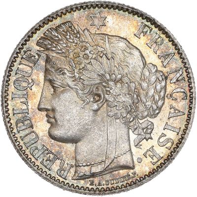 a silver coin with a crown on top of it