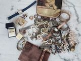 un sac à main rempli de bijoux posé sur une table en marbre