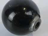 an image of a black ball on a white surface
